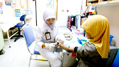 A young girl visits her pediatrician in Kuala Lumpur. (Photo: Kevin Tachman)